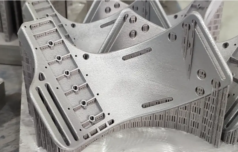 As-printed metal 3D printed parts showing the typical surface finish and support structures after additive manufacturing.