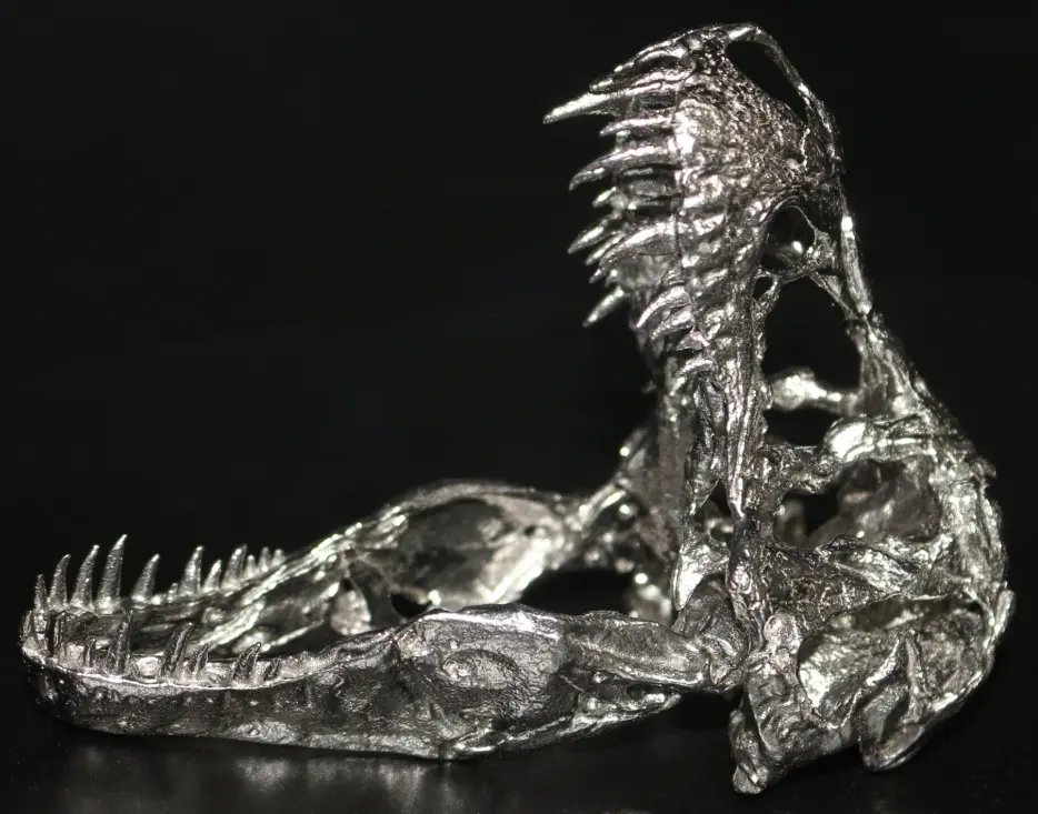 Metal 3D printed skull model with a tumbled surface finish for smoother edges and improved appearance