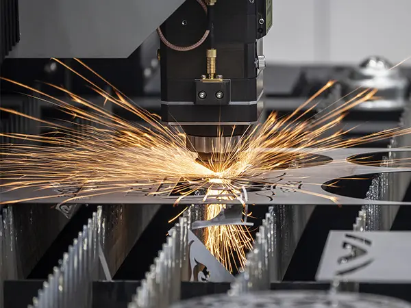 Laser cutting machine cutting a metal sheet with sparks