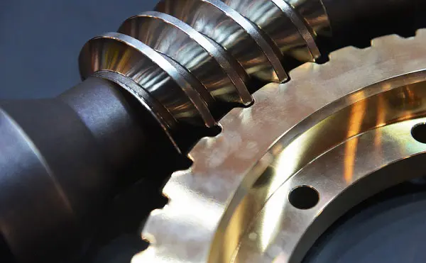 Gear hobbing process showing a hob cutter machining the teeth of a metal gear