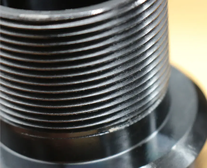Black-coated CNC machined metal part with precision threads