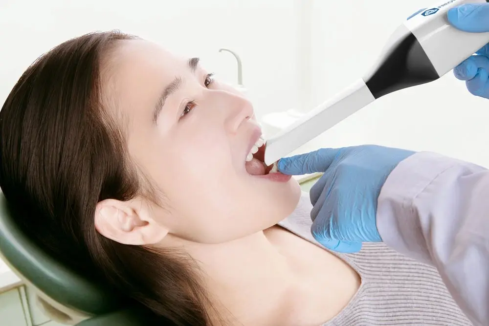 Dentist using an intraoral scanner to capture a digital impression of a patient's teeth
